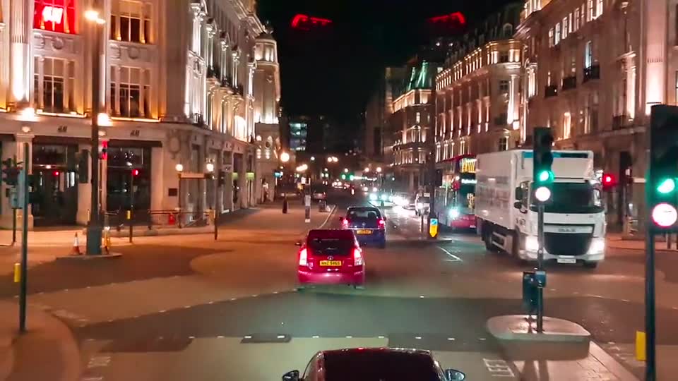 Drivers travelling through a London street at night
